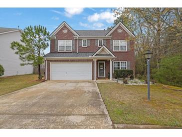 Charming two-story brick home featuring a well-manicured lawn and two-car garage with nice curb appeal at 3000 Storybook Ln, Grayson, GA 30017