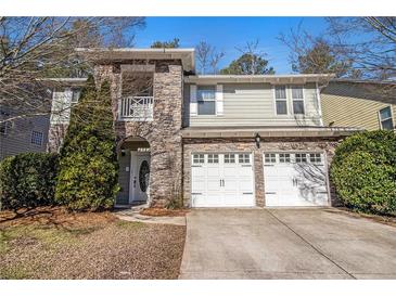 Charming two-story home with a stone facade, two-car garage, and well-maintained landscaping at 4319 Alysheba Dr, Fairburn, GA 30213