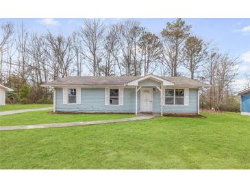 Charming single story home with light blue siding and a well maintained lawn at 8199 Cousins St, Douglasville, GA 30134