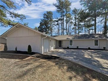 Charming single-story home features a brick exterior, attached garage and a beautifully landscaped front yard at 5520 Morning Creek Cir, Atlanta, GA 30349