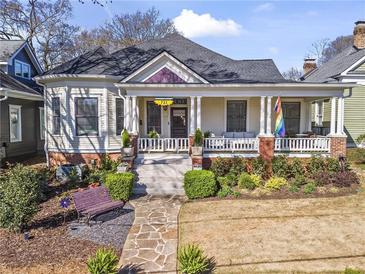 Charming home features a welcoming front porch, landscaped yard, and stone pathway to the front door at 733 Cherokee Se Ave, Atlanta, GA 30315