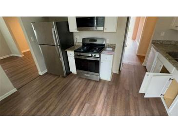 Well-lit kitchen with stainless steel appliances and granite countertops at 1815 Boulderview Se Dr, Atlanta, GA 30316