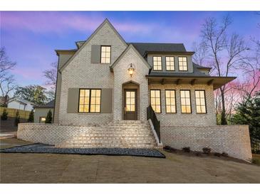 Charming home with a brick exterior, manicured lawn, and inviting front entrance at 375 Chattahoochee St, Roswell, GA 30075