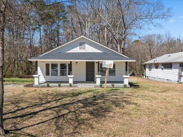 Charming one-story home with white siding, a covered porch, and a well-manicured front lawn at 1190 Dallas Hwy, Villa Rica, GA 30180