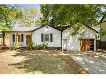 Charming single-story home featuring a newly paved driveway and inviting front porch at 1377 Marston St, Smyrna, GA 30080