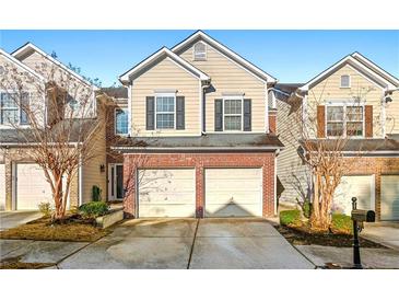 Traditional townhouse with a two-car garage and well-maintained landscaping in a suburban setting at 5538 Cascade Sw Rdg, Atlanta, GA 30336