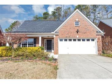 Charming brick home with a two-car garage, inviting front yard, and a well-maintained lawn at 499 Bellbrook Ln, Lawrenceville, GA 30045