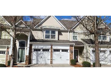 Charming townhome featuring a two-car garage and traditional architectural details at 3512 Clear Creek Crossing, Kennesaw, GA 30144