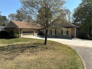 Charming single-story home with stone accents and a welcoming driveway and attached two car garage at 2894 Dellinger Dr, Marietta, GA 30062