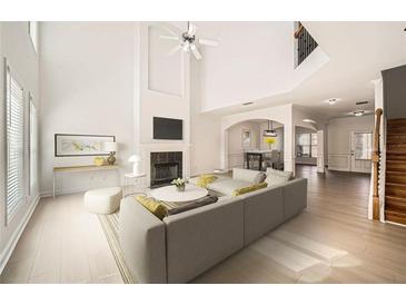 Bright, open living room with fireplace, vaulted ceiling, and hardwood floors at 379 Peachstone Way, Lawrenceville, GA 30043