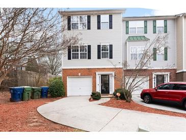 Charming townhome with attached garage and well-manicured front yard at 700 Celeste Sw Ln, Atlanta, GA 30331