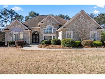 Charming brick home with landscaped yard, walkway, and beautiful entryway at 2304 New Haven Pl, Conyers, GA 30094