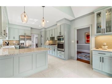 Bright kitchen featuring stainless steel appliances, a center island, and stylish pendant lighting at 3720 Harts Pl, Atlanta, GA 30341