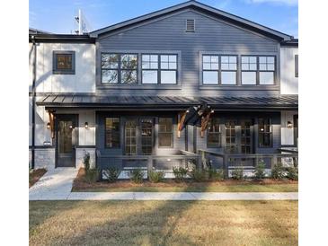 Charming townhome featuring a modern facade and well-manicured lawn at 937 Willingham Dr # 7, Hapeville, GA 30354