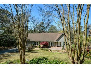 Charming single-story home featuring a well-manicured lawn, mature trees, and inviting front entrance at 2112 Starfire Ne Dr, Atlanta, GA 30345
