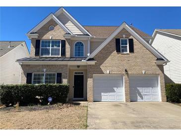 Charming two-story brick home featuring a two-car garage and well-maintained landscaping at 1295 Leisure Lake Dr, Lawrenceville, GA 30044