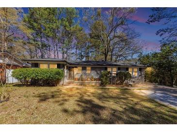 Charming single-story home featuring a brick facade, well-maintained lawn, and mature trees at 2754 Drew Valley Ne Rd, Atlanta, GA 30319