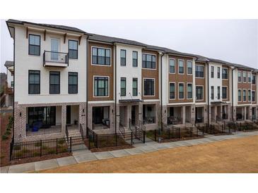 Modern townhome exteriors with mixed brick and board and batten and black framed windows at 334 Olmstead Way # 37, Alpharetta, GA 30022