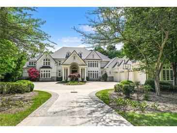 Stunning traditional home with circular driveway, manicured landscaping and attached three car garage at 510 Covington Cv, Alpharetta, GA 30022
