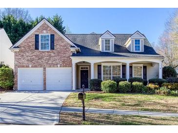 Charming two-story home with a brick facade, covered porch, and well-maintained landscaping at 500 Sapphire Valley Ln, Canton, GA 30114