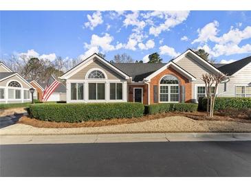 Charming single-story home with manicured landscaping and inviting curb appeal on a sunny day at 938 Burnt Hickory Nw Cir, Marietta, GA 30064