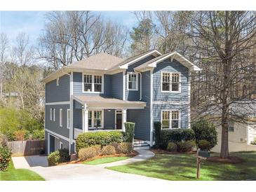Charming two-story home featuring a welcoming front porch and manicured landscaping at 152 Park Dr, Decatur, GA 30030