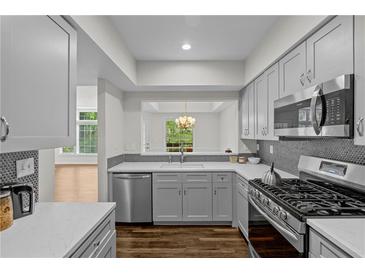 Modern kitchen with gray cabinets, stainless steel appliances, and backsplash at 3636 Habersham Nw Rd # 2208, Atlanta, GA 30305