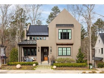 Charming two-story home with modern design, manicured landscaping, and inviting front porch at 321 Mado Ln, Chattahoochee Hills, GA 30268