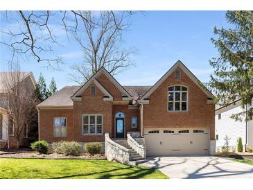 Charming brick home boasts meticulous landscaping, a two-car garage, and a welcoming stone stairway to the front door at 1244 Kingsley Ne Cir, Atlanta, GA 30324