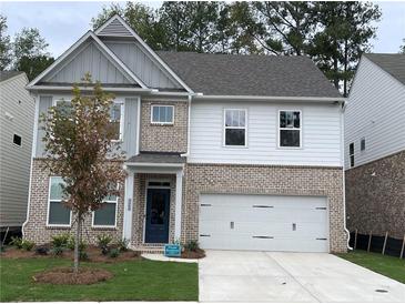 Charming two-story home featuring brick accents, gray siding, and a convenient two-car garage at 4375 Easter Lily Ave Lot 81, Buford, GA 30519