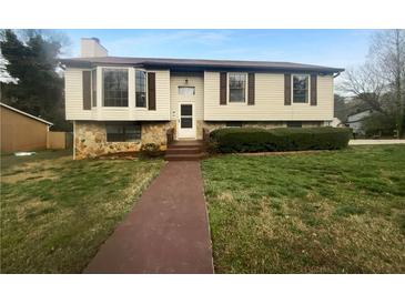Charming home featuring stone accents and lush landscaping at 4933 Bayside Ct, Stone Mountain, GA 30088