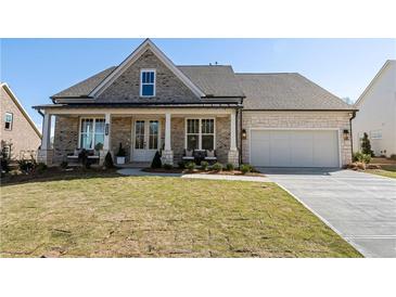 Charming single-Gathering home with a covered front porch and a well-manicured lawn at 5120 Token Chase, Cumming, GA 30040