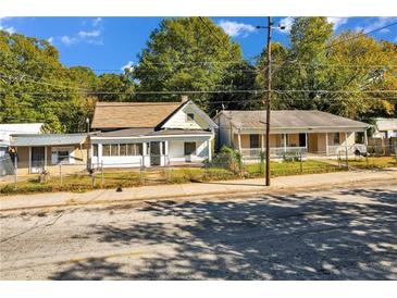 Two modest, single-Gathering homes with fenced yards and mature trees at 1640 Lakewood Se Ave, Atlanta, GA 30315