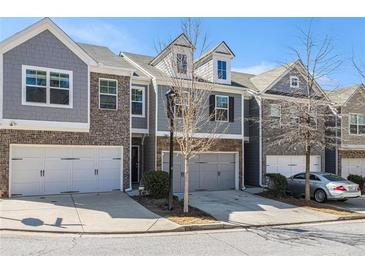 Charming townhome featuring a two-car garage and a welcoming exterior at 1530 Redbud Way, Tucker, GA 30083