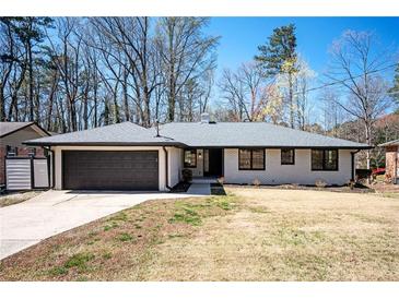 Charming one-story brick home with a two-car garage and a well-manicured lawn at 2722 Glenbriar Ne Dr, Atlanta, GA 30345