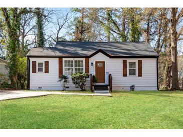 Charming single-story home featuring a well-manicured lawn and classic architectural details at 2072 Baker Nw Rd, Atlanta, GA 30318