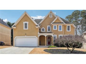 Charming two-story home with a well-manicured lawn and attached two-car garage at 385 Sweet Ivy Ln, Lawrenceville, GA 30043