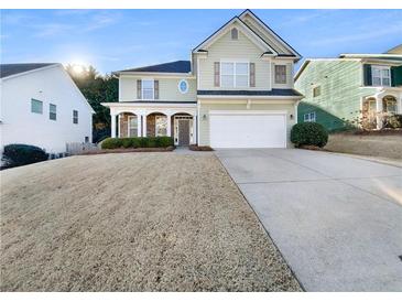 Charming two-story home with a well-manicured lawn and a welcoming front porch at 412 Pine Log Ct, Canton, GA 30115