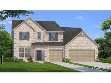Charming two-story home with brick facade, well-manicured lawn, and a three car garage at 141 Compass Rd, Hampton, GA 30228