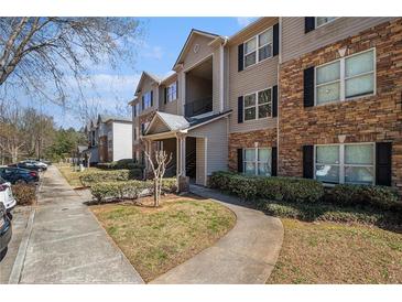 Attractive apartment building with stone accents, manicured landscaping, and convenient parking at 5303 Fairington Club Dr # 5303, Lithonia, GA 30038