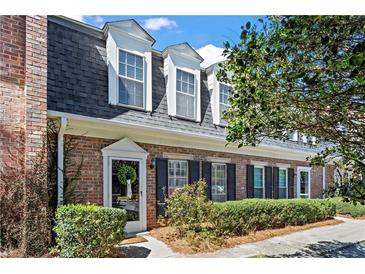 Charming brick townhome with well-maintained landscaping and traditional architectural details at 9 Market Square Nw Pl, Atlanta, GA 30318