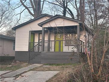 Charming bungalow featuring a welcoming porch, a newly painted facade, and a vibrant green door at 1170 Booker Sw Ave, Atlanta, GA 30310