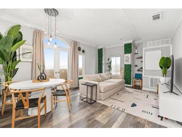 Bright living room featuring a dining table, modern furniture, and light hardwood floors at 2161 Peachtree Ne Rd # 508, Atlanta, GA 30309