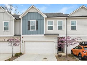 Charming two-story townhome featuring a two-car garage and lovely curb appeal with manicured landscaping at 456 Millsap Way, Marietta, GA 30060