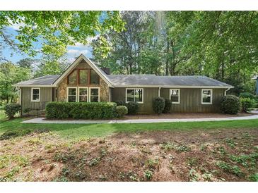 Charming single-story home with stone accents, mature trees, and well-maintained landscaping at 3252 Westbrook Trce, Lawrenceville, GA 30044