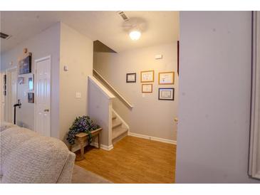 Inviting entryway featuring hardwood floors, staircase, and tastefully decorated wall art, creating a warm and welcoming ambiance at 7130 Oakley Ct, Union City, GA 30291