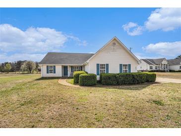 Charming single-story home with blue shutters and manicured hedges at 340 Nail Rd, Mcdonough, GA 30253