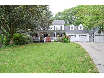 Charming two-story home with a large front porch and well-manicured lawn at 5500 Georgetown Sw Trce, Lilburn, GA 30047