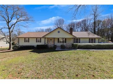 Charming single-story home featuring a welcoming front porch and manicured lawn at 133 Hickory Trl, Cumming, GA 30040