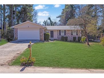 Charming one story brick home with a well-manicured lawn, attached garage and inviting curb appeal at 2911 Botany Dr, Jonesboro, GA 30236